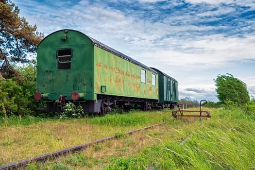 old wagons and tracks on the former railway line to Fischland-Darss peninsula, Bresewitz, Mecklenburg-Western Pomerania, Germany
