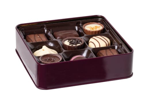 Closeup of box of fine chocolate candies in a beautiful box isolated on a white background. Clipping path. Surprise gift for Valentine's Day or other festive occasions. Macro.