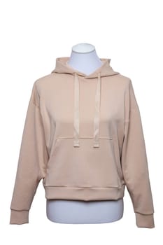 Female elegant beige hooded sweatshirt with long sleeves on mannequin for print isolated on a white background. Clipping path. Autumn fashion.