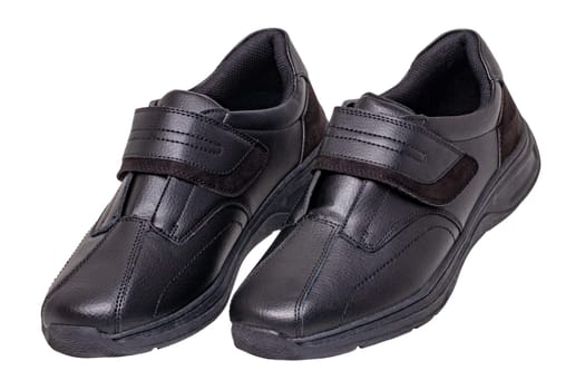 Mans black shoes. Close-up of a pair of black sneakers or sport shoes isolated on a white background. Clipping path. Elegant and trendy mens footwear. Macro.