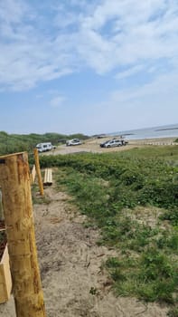 View over the sea from the dune over North Sea and canal in Ouddorp, Zeeland province, The Netherlands. Outdoor scene of coast in Europe nature.
