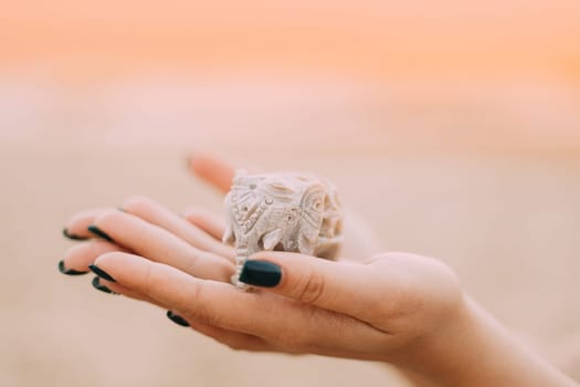 Goa, India. Elephants Souvenirs Of Stone In Woman's Hand.