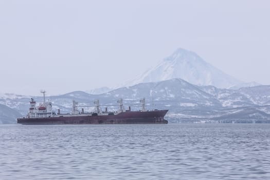 The Kamchatka Peninsula, Russia.Seaport in Petropavlovsk-Kamchatsky.Ships in the roadstead against the background of the volcano