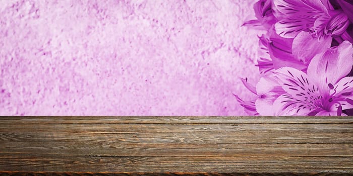 Background flowers on a textured stucco wall and blank wooden planks in the foreground. For product demonstrations, free space, layout, mockup, perspective board, background board.