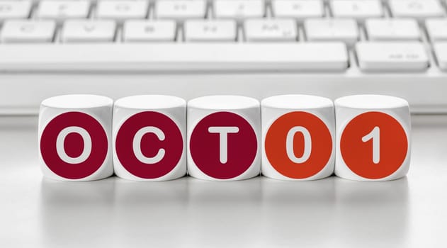 Letter dice in front of a keyboard - October 01