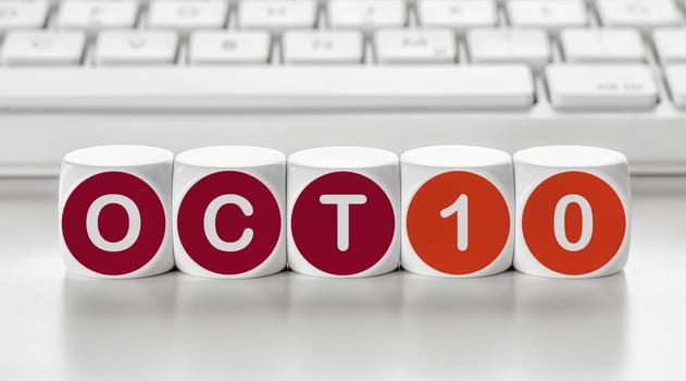 Letter dice in front of a keyboard - October 10