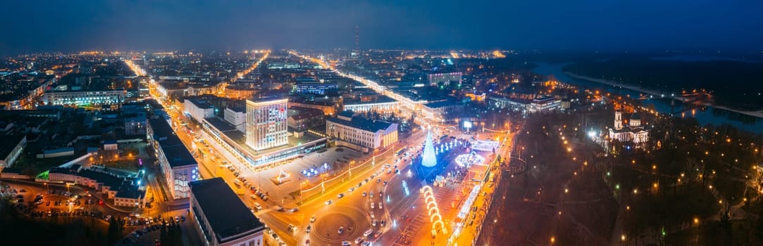 Gomel, Belarus. Main Christmas Tree And Festive Illumination On Lenin Square In Homel. New Year Celebration In Belarus. Aerial Night View. Panorama.