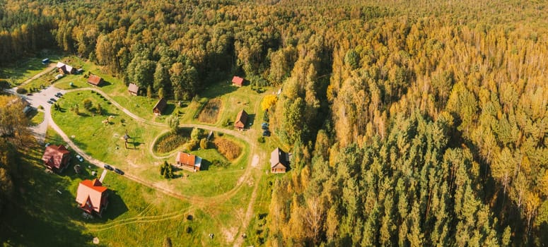 Belarus, Berezinsky Biosphere Reserve. Aerial Bird's-eye View Of Guest House Nivki In Autumn Sunny Day. Panorama, Panoramic View Of Nivki Tourist Complex.
