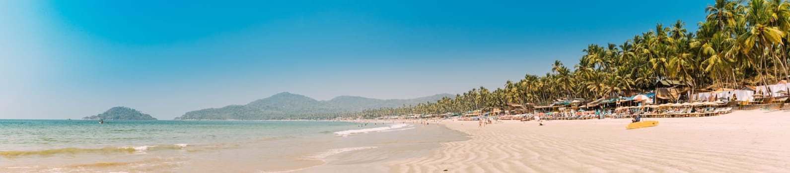 Canacona, Goa, India. Sunny Sky Over Calm Water Of Arabian Sea. Natural Landscape With Sandy Palolem Beach At Sunny Summer Day With Blue Sky.