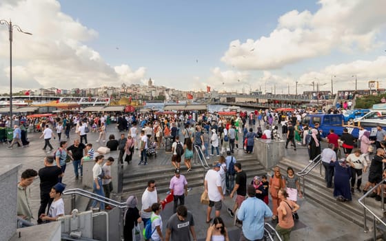 Istanbul, Turkey - August 30, 2022: Crowds of local citizens at Eminonu Piazza during the Victory Day holiday with background of Istanbul city view including Galata Tower