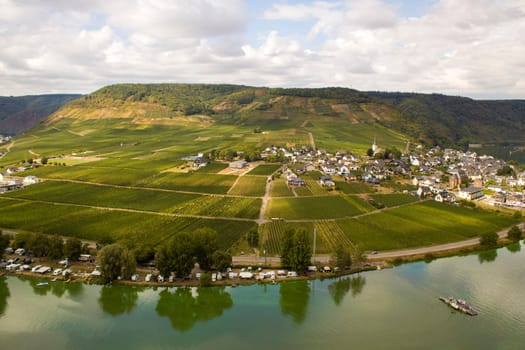 Aerial view of the Moselle valley with vineyards, the river Moselle and the villages Ellenz-Poltersdorf and Poltersdorf seen from castle Metternich in Beilstein, Rhineland-Palatinate, Germany.