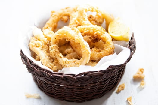 close up of basket of golden italian fried calamari
