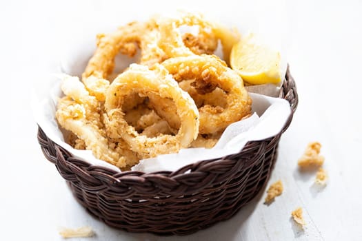 close up of basket of golden italian fried calamari