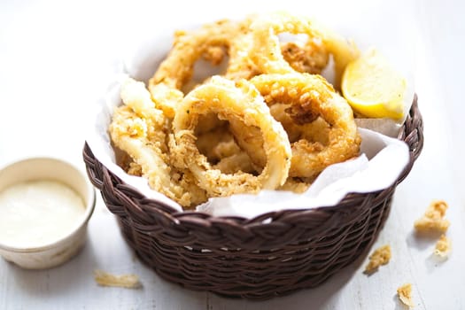 close up of basket of golden italian fried calamari