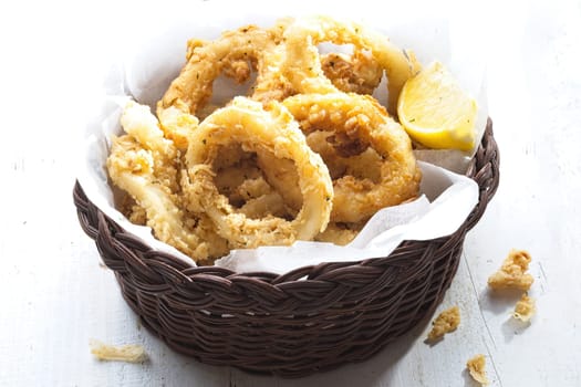 close up of basket of golden italian fried calamari