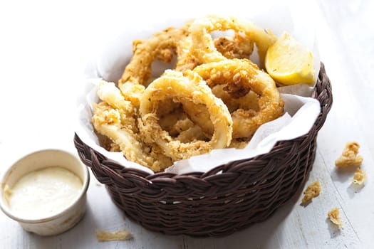 close up of basket of golden italian fried calamari