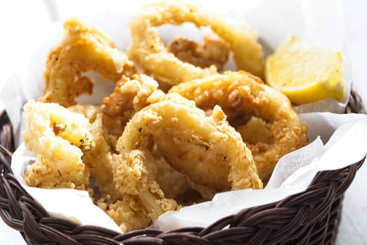 close up of basket of golden italian fried calamari