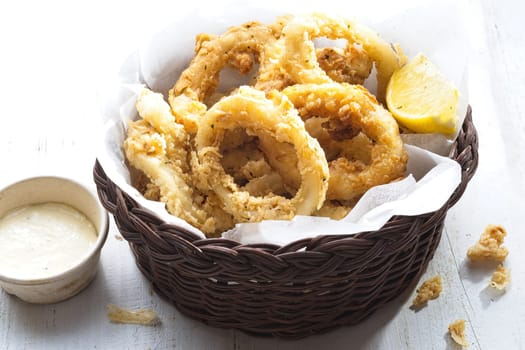 close up of basket of golden italian fried calamari