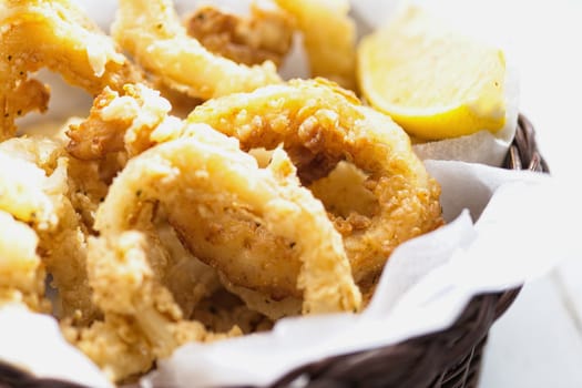close up of basket of golden italian fried calamari