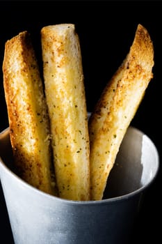 close up of sticks of golden garlic bread