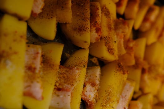 Delicious Potato Bratkartoffeln With Bacon close up in the plate on ready to bake.