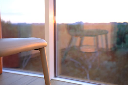 modern bliege chair in empty office space with large window, vintage picture style process,copy space
