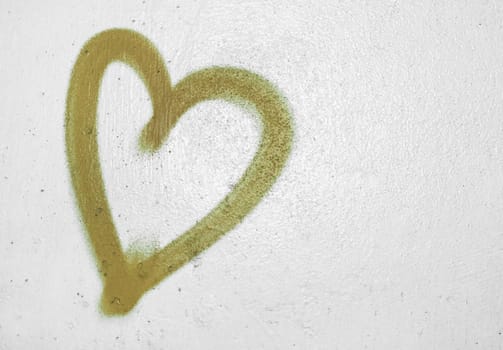 Concept or conceptual painted golden abstract heart shape love symbol, dirty wall  background, metaphor to urban and romantic valentine, grungy style.