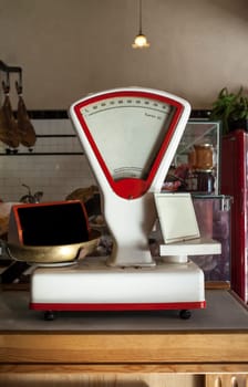 Old white scale over wooden grocery counter. Vintage background