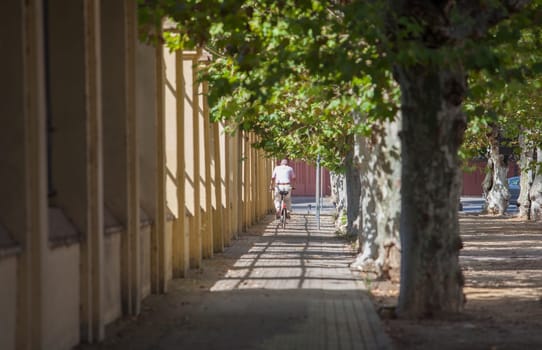Senior biker riding at Seville downtown, Spain. Mild bike rides around the city for the elderly