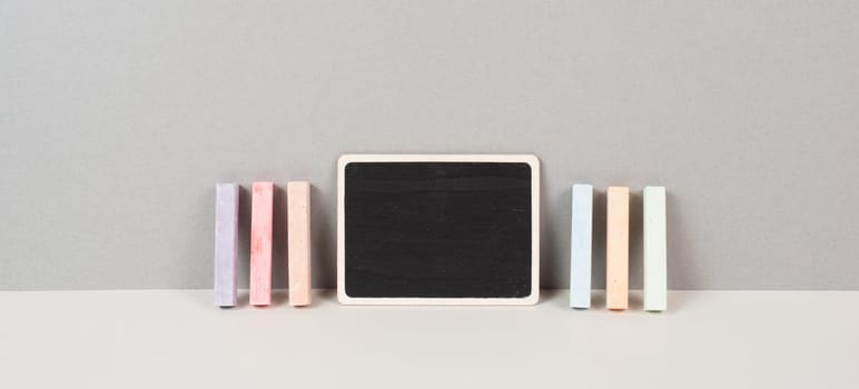 Blank chalkboard with colorful chalk, back to school, education concept