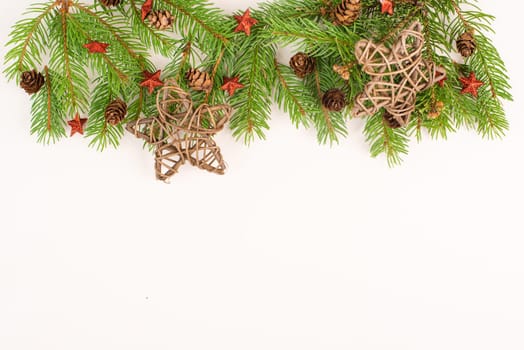 Christmas holiday background, fir branches, red stars and cones, winter season greeting card, copy space