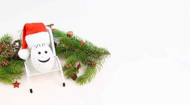 Santa Claus with a red hat sitting in a lounge chair, holiday by the sea, taking a vacation, christmas decoration with fir, cones and stars