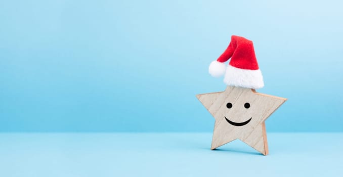 Star with a happy smiling face expression, red christmas hat, winter greeting card and banner, copy space
