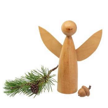 Turned wooden angel figure decorated with pine cones and pine needles isolated on white