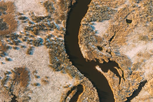 Belarus. Aerial View Of Dry Grass And Curved River Landscape In Early Spring Day. High Attitude View. Marsh Bog. Drone View. Bird's Eye View.