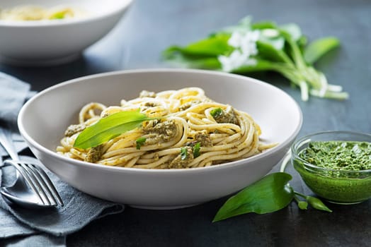 Making Fresh pasta with ramson or wild garlic pesto closeup. Healthy spring food concept
