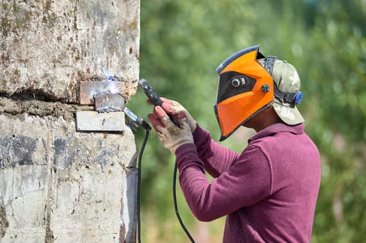 The welder welds reinforced concrete products together. High quality photo
