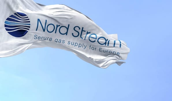Greifswald, GER, September 2022: Flag with the Nord Stream logo waving to the fan on a clear day. Nord Stream is a gas pipeline that directly transports Russian gas to Western Europe.