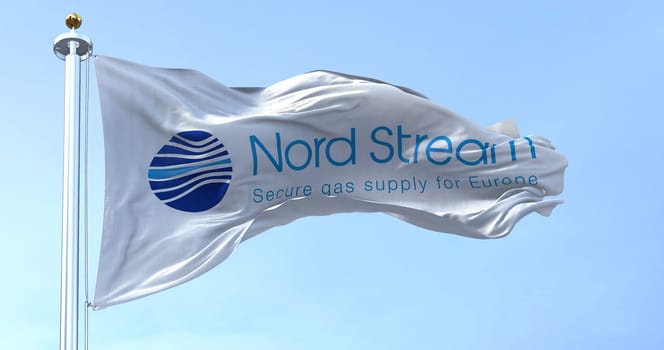 Greifswald, GER, September 2022: Flag with the Nord Stream logo waving to the fan on a clear day. Nord Stream is a gas pipeline that directly transports Russian gas to Western Europe.