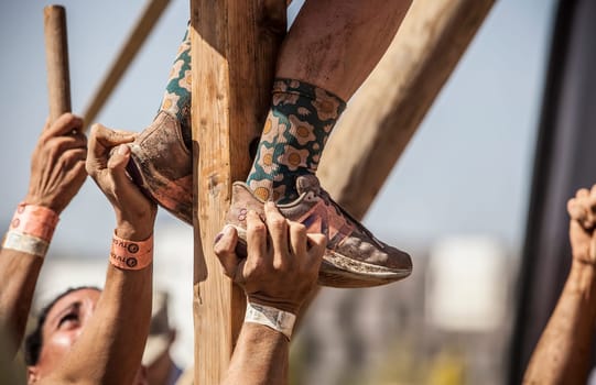 Merida, Spain - Sept 11th, 2022: FarinatoRace Merida 2022. Teammates helping to climbing pole
