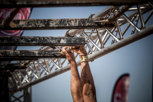 Merida, Spain - Sept 11th, 2022: FarinatoRace Merida 2022. Toughest obstacle course in the world. Brachiation or arm swinging