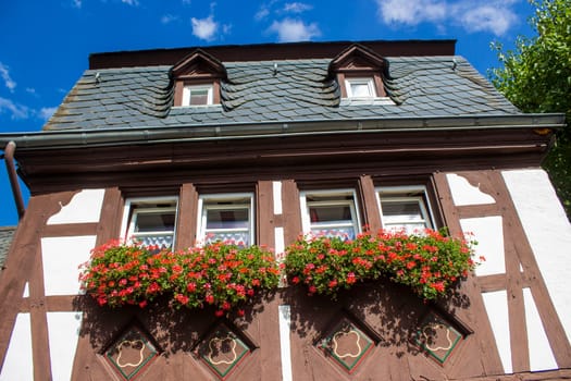 Building in Beilstein - historic village along the river Moselle with old half-timbered houses and the ruins of castle Metternich on top of the hills, Germany