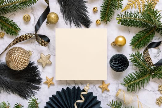 Square Paper card between black and golden Christmas decorations and fir tree branches top view. Winter composition with blank invitation card Mockup, copy space