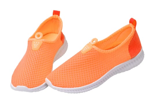 Orange sneaker isolated. Close-up of women's trendy athletic shoes or sport sneakers isolated on a white background. Modern footwear design for workout. Macro.