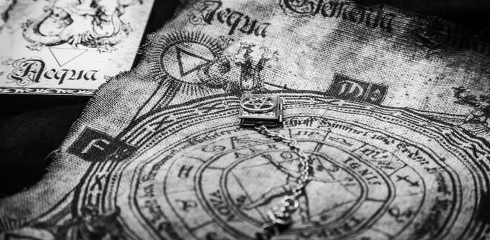Ancient esoteric witchcraft background. Occultims and paganism old symbol, with mysterious runes and alphabet.
