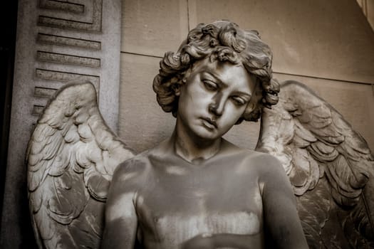GENOA, ITALY - June 2020: antique statue of angel (beginning 1900, marble) in a Christian Catholic cemetery - Italy