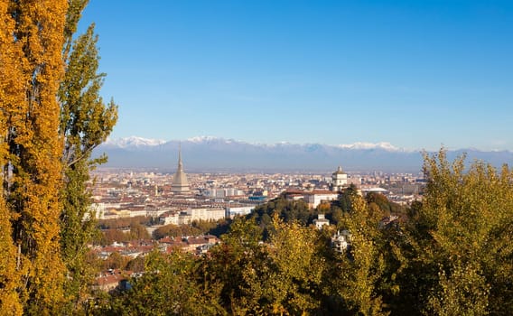 Turin, Italy - Circa November 2021: panorama with Alps and Mole Antonelliana,. Skyline of the symbol of Piedmont Region withi Monte dei Cappuccini - Cappuccini's Hill. Sunrise light, Autumn.