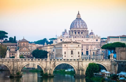 ROME, ITALY - JUNE 2020: sunset panorama on Tiber river bridge with Saint Peter Cathedral dome (Vatican City) in background - Rome, Italy