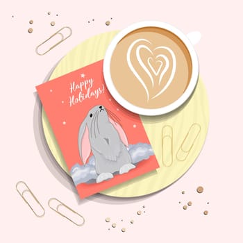 Morning post. A cup of coffee and a card with the symbol of 2023. Congratulatory Christmas card with a rabbit. View TOP. RABBIT.