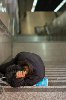 A homeless male slept at metro station steps